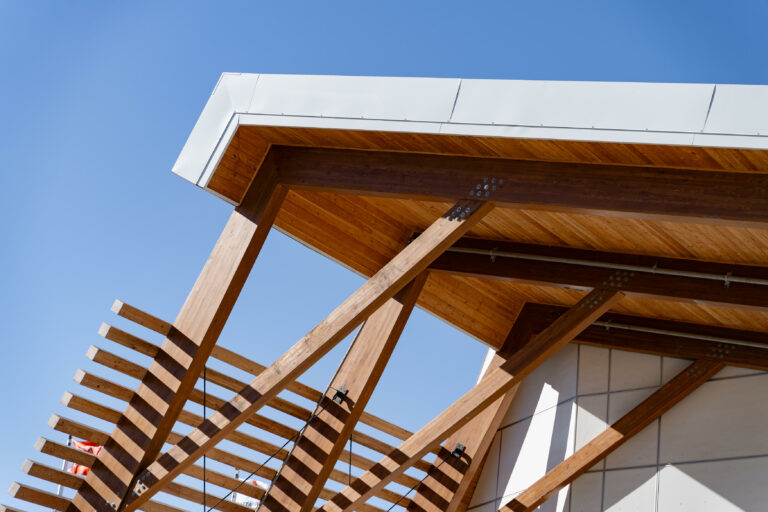 Angled view of roof meeting glulam beams and canopy.