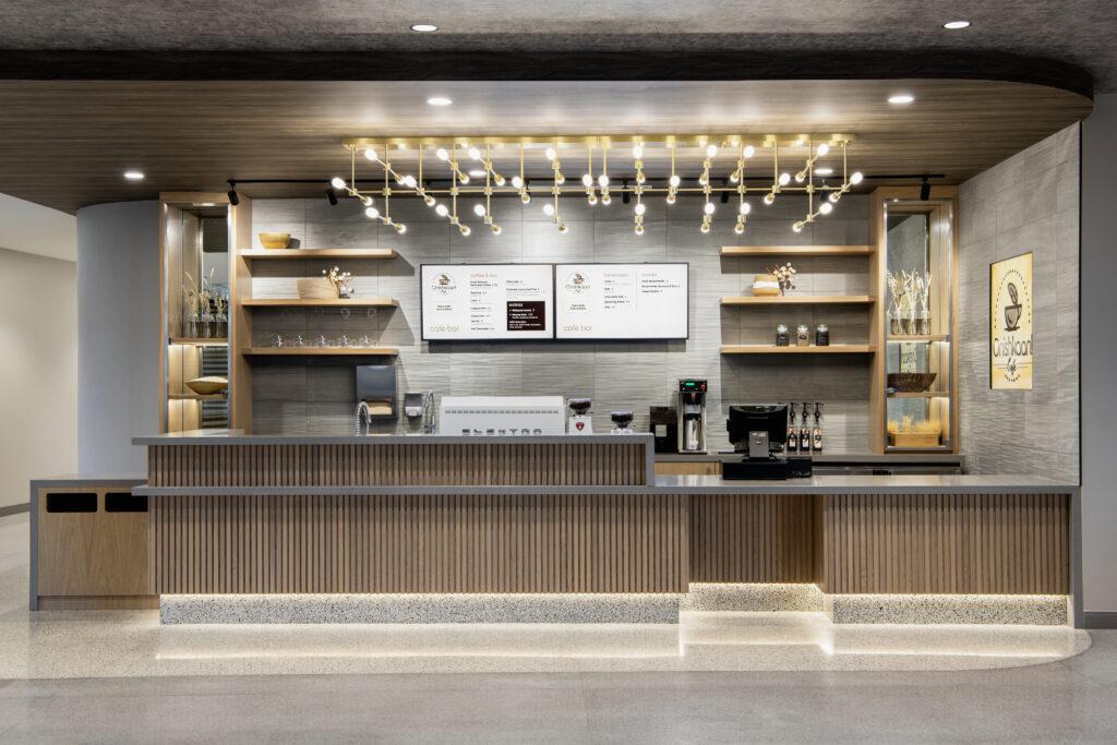 Café counter and shelves behind the counter and large lighting fixture above